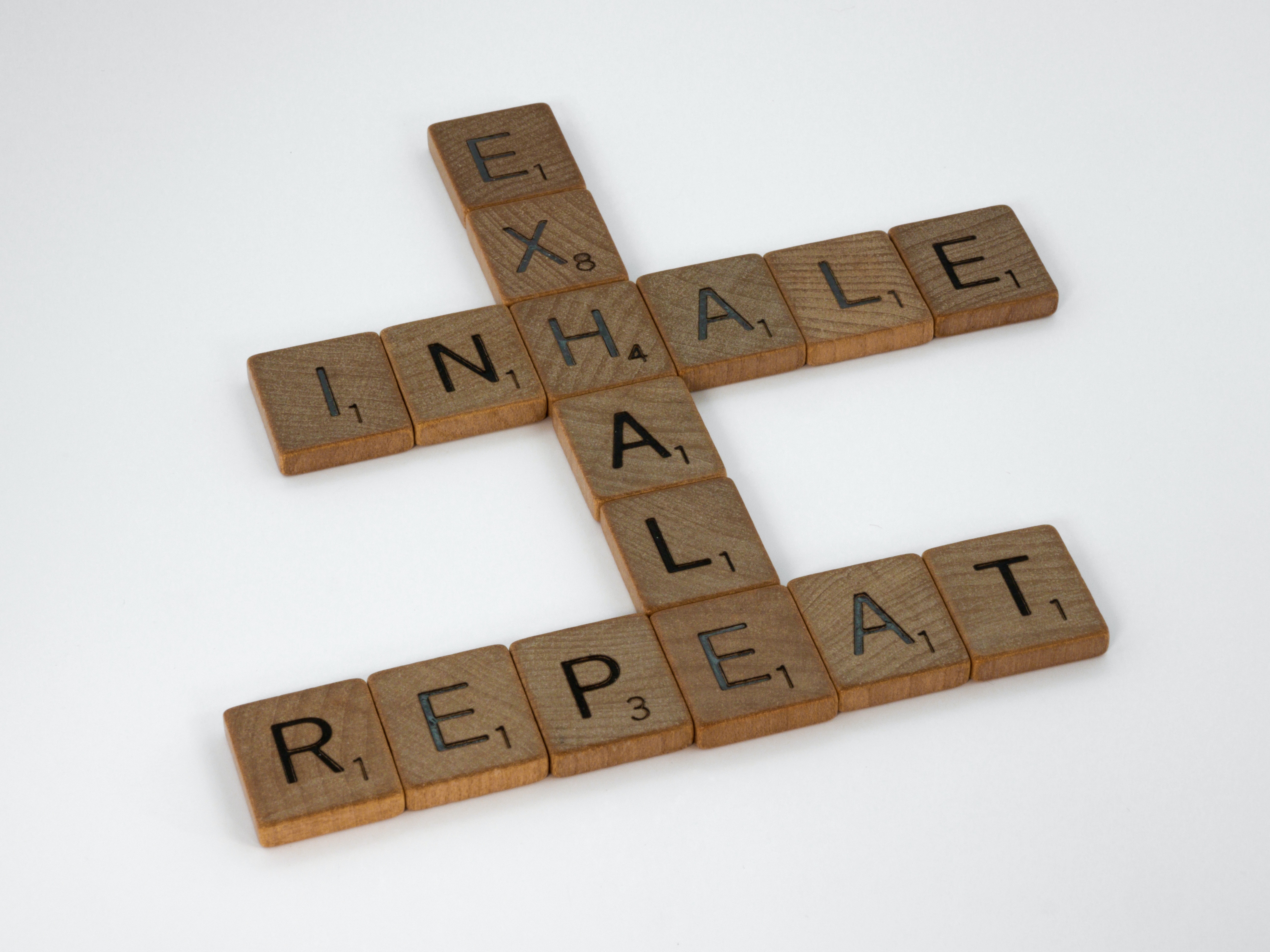 Scrabble tiles reading inhale, exhale, repeat